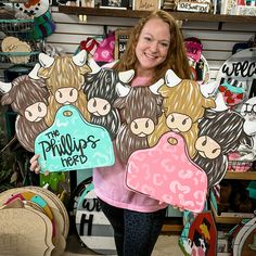 a woman holding up two cardboard cutouts of cows and the words, the phillip's hope