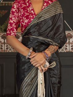 Experience the timeless elegance of tradition with our exquisite black silk saree, adorned with intricate weaving work. This saree, measuring 5.50 meters, is a masterpiece of craftsmanship, offering a perfect blend of sophistication and cultural heritage. The delicate weaving work on the rich black silk not only enhances its beauty but also adds a touch of regality, making it a perfect choice for any festive occasion.
Whether it's a family gathering, a religious celebration, or a special event, Black Art Silk Pre-draped Saree With Zari Weaving, Black Pre-draped Saree With Zari Weaving For Puja, Black Silk Handloom Pre-draped Saree, Black Bollywood Handloom Pre-draped Saree, Traditional Black Pre-draped Saree, Festive Black Pre-draped Saree With Cutdana, Black Pre-draped Saree With Pallu For Festive Occasions, Elegant Black Silk Pre-draped Saree, Black Pre-draped Saree With Traditional Patterns