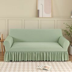 a living room with a green couch and white rug