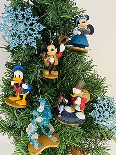 a christmas tree with mickey mouse ornaments hanging from it