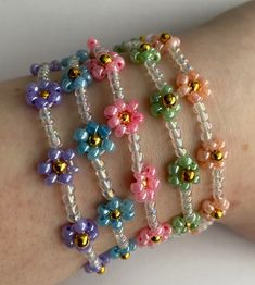 a woman's arm with several bracelets made out of beads and glass beads