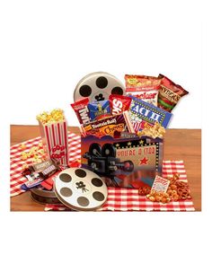 the popcorn box is filled with movies and snacks, along with a movie reel as well