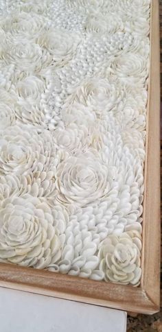 a close up of a table with white flowers on the top and bottom part of it