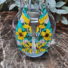 Shop ascsbeauty1's closet or find the perfect look from millions of stylists. Fast shipping and buyer protection. These beautiful YELLOW FLOWER fringe earrings were beaded by me using Japanese Delica Beads in the colors Canary Yellow, Topez, Rootbeer, Blue Turquoise, Dark Green Rainbow and Coral Luster. They measure approximately 4" in length and 1.25 in width. I hope you enjoy wearing them as much as I had making them. Beaded Multicolor Flower Earrings For Summer, Multicolor Beaded Flower Earrings For Summer, Yellow Round Bead Jewelry For Summer, Yellow Beaded Earrings For Summer, Yellow Beaded Earrings For Summer Beach, Yellow Round Beads Jewelry For Summer, Summer Multicolor Beaded Flower Earrings, Adjustable Multicolor Flower Earrings With Colorful Beads, Yellow Beaded Earrings With Ear Wire For Festivals