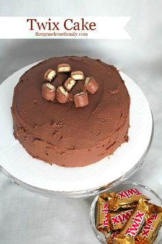 there is a chocolate cake with nuts on top and candy in the bottom, next to it