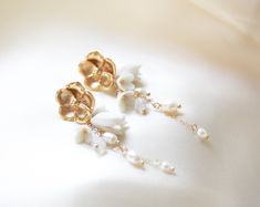 Make a statement on your special day with our gorgeous CALLIE Freshwater Pearl Floral Earrings! Perfect for any modern bride, they combine golden tones with glimmering pearl accents to create an exquisite flowery design. A must-have accessory to complete your look! - PLEASE ALLOW APPROX 10 BUSINESS DAYS FOR COMPLETION BEFORE SHIPPING. - Handcrafted with genuine freshwater pearls and Austrian crystals- Created in my studio in PA- White opal crystals- Freshwater pearls- Polymer clay flowers- Yello Earrings For Bride, Polymer Clay Flowers, Clay Flowers, Opal Crystal, Floral Earrings, Modern Bride, Austrian Crystal, White Opal, Fresh Water