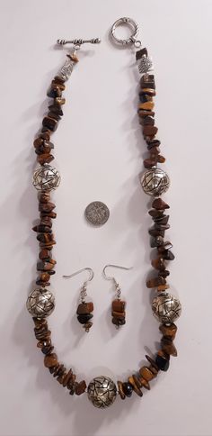 Handmade Boho Womens Girls Genuine Golden Tiger's Eye Large Chunky Beads Gemstones Jewelry Excellent Gift Bracelet Rich Natural Colors One of a Kind Beautiful handmade special Golden Tiger's Eye gemstone necklace earring set...GORGEOUS! Golden colors large sized polished chunky high grade gemstone beads in silver tone Artisan designer findings. VERY COOL Necklace 22 inches earrings 1.5 inches Easy to wear comfortable. Super high quality. Treasured gift comes in box. Easy to wear casual chic vint Adjustable Brown Jewelry With Silver Beads, Costume Jewelry With Round Beads And Stones, Brown Polished Beads Jewelry Gift, Spiritual Metal Beads Jewelry For Gift, Brown Dangle Jewelry With Natural Stones, Brown Dangle Earrings With Natural Stones, Spiritual Beaded Metal Jewelry, Brown Natural Stone Dangle Earrings, Spiritual Metal Beaded Jewelry