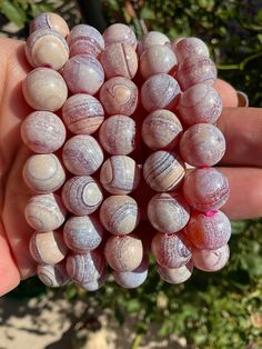 Absolutely beautiful pink plume medicine agate beaded bracelets! In the last photos you can see how the color changes when wet, I just sprinkle water drop on each bracelet. Pink plume agate from East Java is a beautiful combination of tectonic and volcanic activity. Plume agate is believed to be a stone of new beginnings, refreshing the soul, making you able to see the beauty you behold. Plume agate is also believed to promote self expression and communication, also balance emotions allowing you Plume Agate, Self Expression, East Java, Crystal Beads Bracelet, Agate Jewelry, Agate Crystal, Pink Bracelet, Water Drop, Agate Beads