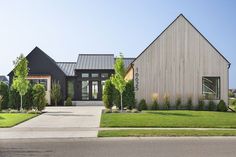 a house that is on the side of a road with grass in front of it