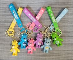 four key chains with different colored bears on them