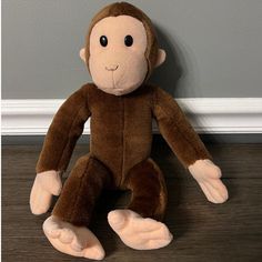 a stuffed monkey is sitting on the floor