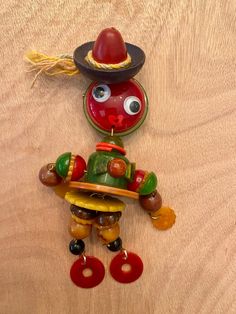 a wooden table topped with a red and green toy