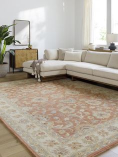 a living room with a large rug on the floor and a couch in front of it