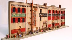 a model of an old building with red shutters