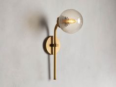 a wall light with a glass ball on it