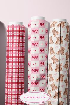 four rolls of pink and white checkered wrapping paper with teddy bears on them, one in the center