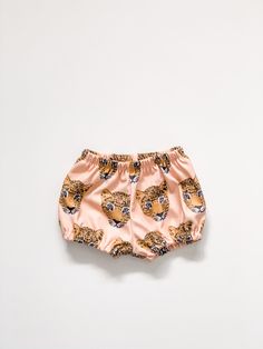 Your little girl will look so stylish in these adorable bloomers, and they are super comfy to boot. Pair these with the coordinating peplum tank for an outfit your little lady will love!. These stylish bloomers feature 100% organic cotton knit produced in the USA that is certified organic by global organic textile standards so you can feel good about dressing your baby in these day after day! We serge all seams for added durability and strength and use high quality braided elastic for the waistb Summer Diaper Cover With Elastic Waistband, Cute Pink Bloomers For Playwear, Cute Shorts With Elastic Waistband For Playwear, Cute Pink Short Bloomers, Cute Short Pink Bloomers, Cute Pink Bloomers With Elastic Waistband, Summer Playful Diaper Cover With Elastic Waistband, Cute Bloomers With Elastic Waistband For Playwear, Playful Summer Diaper Cover With Elastic Waistband