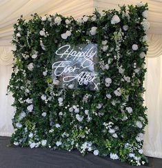 a wedding backdrop with white flowers and greenery