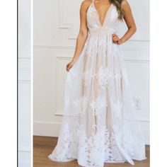 Step Into Elegance With This Stunning Luxxel Nude Monochrome Lace Floral Gown, An Absolute Must-Have For Any Formal Event. Tailored To Flatter, This Gown Boasts A Graceful Bust Of 33 Inches And A Snug Waist Of 28 Inches, Cascading Down To A Floor-Length Skirt Of 47 Inches. The Intricate Lace Detailing Ensures You'll Be The Centerpiece Of Any Gathering. Sized Small With A Precise Waist Measurement Of 13.5 Inches Across, It's Designed For A Seamless Fit. #Formalwear #Weddingseason #Elegantstyle #F White V-neck Gown With Lace Bodice, Backless Lace Bridesmaid Dresses, Backless Maxi Dress With Lace Bodice For Prom, Summer Lace Prom Gown, Summer Lace Gown For Prom, Cream Maxi Dress For Prom, Elegant White Sheer Maxi Dress, White Backless Lace Dress With Lace Back, White Sleeveless Gown With Lace Back