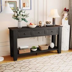 a living room with a black table and pictures on the wall