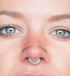 a woman with piercings on her nose