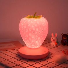 a strawberry shaped light sitting on top of a table