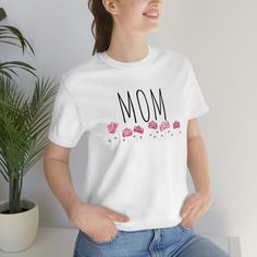 Mom T-Shirt For The Mom in Your Life.  She will love wearing what she's proud of most right on her shirt - being a Mom. Shirt: Bella+Canvas 3001 These t-shirts have-ribbed knit collars to bolster shaping.  The shoulders have taping for better fit over time. Dual side seams hold the garment's shape for longer.  -100% Airlume combed and ringspun cotton (Ash - 99% cotton and 1% polyester) -Runs true to size -With side seams located along the sides, they help hold the garment's shape longer and give Mother's Day Gift Cotton T-shirt, Mother's Day Graphic Tee T-shirt Gift, Mother's Day Gift Graphic Tee T-shirt, Mother's Day Pre-shrunk Cotton T-shirt, Mother's Day Gift Graphic Tee, Pre-shrunk Cotton T-shirt For Mother's Day, Cotton Short Sleeve T-shirt For Mother's Day, Mother's Day Graphic Tee With Funny Text, Mother's Day Cotton T-shirt With Text Print