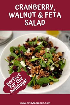 a white bowl filled with spinach, walnuts and feta salad