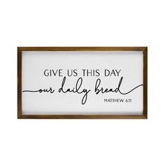 a framed sign with the words give us this day our daily bread written on it