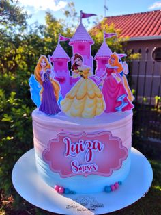 there is a birthday cake with princess figures on it