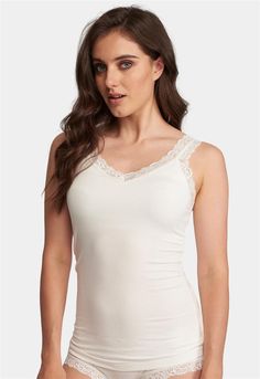 Fleur't's Lace Strap Camisole is the perfect go-to layering piece. Soft and subtle, this cami can be worn underneath most tops, blouses and knits - yet covered enough to be worn on hot summer days and nights. Made of cloud-soft, eco-friendly fabric and edged with 1 inch delicate stretch lace.  Features: •Mid-length hits right below hips • Eco-friendly, cloud-soft TENCEL™ Modal x Eco Soft technology fabric •Curved V-neck and double lace strap for soft, feminine appeal •Built-in “no-show” shelf bra for coverage and support  Designed by women. Sustainably sourced and ethically made.  Main Fabric: 94% TENCEL™ Modal x Eco Soft technology, 6% Spandex.  Care Instructions •Hand wash OR machine wash cold in mesh bag on gentle cycle •Lay flat to dry  Style #610 Loungewear Capsule, Oxford Blue, Lace Straps, Lace Camisole, Feminine Look, Stretch Lace, Hot Summer, Summer Days, Mid Length