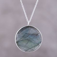 Weighing nine carats, a faceted disc of labradorite evokes the moon in this pendant necklace from India. Believed by the Inuit to possess the hues of the Aurora Borealis, the stone is framed by sterling silver. Neetu Barathi designs this necklace from India. Moon Charm Labradorite Jewelry, Labradorite Jewelry With Moon Charm, Round Labradorite Jewelry With Moon Charm, Labradorite Moon Phase Round Necklace, Round Labradorite Moon Phase Necklace, Labradorite Gemstone Round Necklaces, Labradorite Gemstone Round Necklace, Round Labradorite Gemstone Necklace, Labradorite Gemstone Round Pendant Necklace