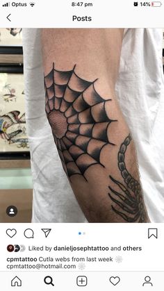 a man with a spider web tattoo on his arm