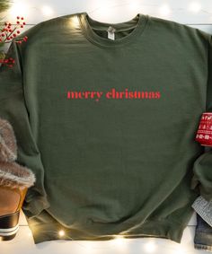 This unisex sweatshirt is for Christmas lovers. Available as a Unisex Sweatshirt or as a Unisex Hoodie. Primary photo = Sweatshirt "Military Green" ♥PRODUCTION TIME: 1-5 days (usually 2-3 days) ♥SHIPPING TIME: 2-5 days (usually 3 days) ♥PRODUCT DESCRIPTION: The Gildan 18000/18500 is ideal for any situation, a unisex heavy blend crewneck sweatshirt/hoodie is pure comfort. These garments are made from polyester and cotton. This combination helps designs come out looking fresh and beautiful. The co Christmas Crew Neck Cotton Sweater, Christmas Cotton Crew Neck Sweater, Christmas Gift Cotton Sweater, Christmas Cotton Sweatshirt, Green Christmas Sweatshirt With Letter Print, Christmas Crew Neck Sweater With Letter Print, Green Christmas Crew Neck Sweatshirt, Christmas Cotton Crew Neck Sweatshirt, Christmas Sweater With Letter Print