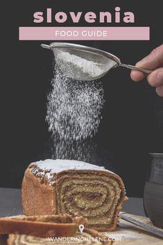 someone is sprinkling sugar on top of a loaf of bread that has been sliced into