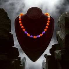 Elevate your Halloween style with Witchie, an enchanting bright orange and purple silicone beaded necklace featuring silver skull metal beads and striking black and gray crystal accent beads. This festive piece is perfect for celebrating the Halloween holiday, seamlessly blending elegance with a touch of playful spookiness. At Jacaranda Concepts, we help you slay your style with jewelry that stands out for all occasions. Witchie is the perfect embodiment of our commitment to providing elegant an Orange Round Beads Jewelry For Halloween, Style With Jewelry, Hand-strung Orange Carnelian Beaded Necklaces, Hand-strung Orange Necklace, Adjustable Hand-strung Orange Necklace, Luxury Orange Hand-strung Beaded Necklace, Necklace Orange, Halloween Necklace, Halloween Style