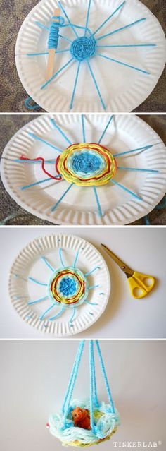 paper plates with yarn on them and scissors hanging from the top, along with another plate that has been made to look like an ornament