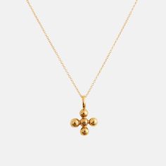 Eonia Cross Pendant Indulge in the timeless artistry of our Eonia Cross, meticulously crafted through an ancient method of melting recycled 14K gold over a charcoal block, forming exquisite spheres expertly assembled to fashion this symbol of eternity. Inspired by the Greek word 'Eonia,' embodying everlasting significance, and intertwined with the symbolism of the number five – emblematic of curiosity, freedom, and change, pivotal to our journey. Our senses - sight, smell, hearing, touch, and taste - enable us to engage with our surroundings and discover new possibilities. It's a harmonious blend of the past and present.This understated yet refined piece is ideal for layering alongside your cherished necklaces or making a statement when worn alone. Perfect for commemorating significant mil Elegant Brass Jewelry With Cross Pendant, Elegant Brass Cross Pendant Jewelry, Yellow Gold Orb Jewelry Gift, Yellow Gold Orb Jewelry For Gift, Tarnish Resistant Yellow Gold Sphere Jewelry, Yellow Gold Brass Jewelry With Round Beads, Classic Sphere Yellow Gold Jewelry, Classic Yellow Gold Spherical Jewelry, Silhouette Jewelry