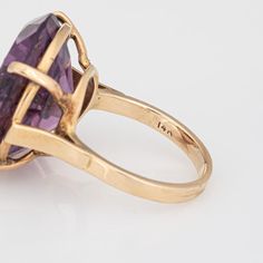 Stylish vintage amethyst & seed pearl ring (circa 1950s to 1960s) crafted in 14 karat yellow gold.   Round faceted amethyst measures 21mm diameter (estimated at 23 carats). The 9 seed pearls each measure 1.5mm. The amethyst is in very good condition and free of cracks or crisps (few light surface abrasions from normal wear).   The rich royal purple amethyst is set with a star pattern of seed pearls, uniquely flush set into the amethyst. The statement ring adds a nice pop of colour on the hand. T Formal Vintage Amethyst Ring, Vintage Yellow Gold Amethyst Ring, Vintage 14k Amethyst Ring, Vintage Gold Amethyst Rings, Vintage Faceted Yellow Gold Rings, 14k Gold Vintage Amethyst Ring For Formal Occasions, Vintage Oval Amethyst Ring In 14k Gold, Vintage 14k Gold Amethyst Ring Hallmarked, Vintage Amethyst Ring With Prong Setting For Anniversary