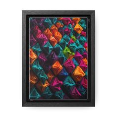 an abstract painting with colorful origami pieces in black frame on white wall background