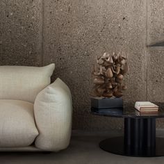 a living room with a couch, coffee table and mushrooms on the wall behind it