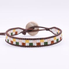 This single wrap leather bracelet is adjustable and has a second loop allowing some extra length.  Size: Adjustable from approx. 6.5-7in              >First Loop at approx. 6.5inches              >Second Loop at approx. 7inches Beads: Glass Seed Beads              >Matte White/Orange/Green/Pink/Yellow   Clasp: Coconut Button               >Brown Leather: Round Leather Cord              >Brown Thread: Nylon Upholstery Thread              >Brown *Photos are taken with care to ensure the color is portrayed correctly. However, due to different screen resolution, screen brightness, lighting, etc... from phone screens to computer screens, colors in the bracelet may differ slightly than pictured. If you have any questions, please don't hesitate to message me. Adjustable Hand Wrapped Leather Bracelet With Round Beads, Adjustable Hand-wrapped Beaded Leather Bracelet, Multicolor Hand Wrapped Leather Bracelet As Gift, Adjustable Colorful Beads Wrap Bracelet, Adjustable Leather Bracelet With Round Beads For Gift, Adjustable Leather Bracelet With Round Beads As Gift, Adjustable Brown Bracelets As Fashion Accessory, Adjustable Multicolor Leather Bracelet With Colorful Beads, Adjustable Multicolor Hand Wrapped Beaded Bracelets