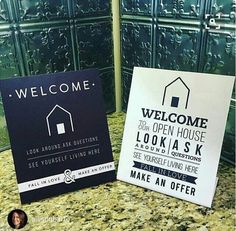 a welcome sign is on the counter in front of a green tile wall and door