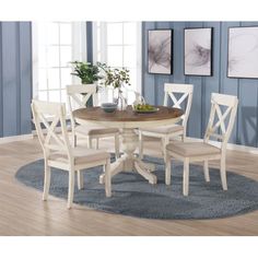 a round dining table with four chairs around it