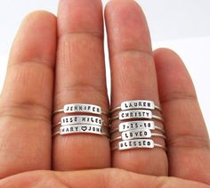 "The listing is for 1 ring. This dainty, personalized ring is a perfect gift for wife, mom, and grandma. The letters are hand stamped with any name, date, inspiration, and motivation word. The letters are tiny, yet very readable, on this petite and dainty ring. Each ring is small enough that many rings can be stacked on a single finger. [ Material ] The band is Argentium silver and the nameplate is sterling silver. Argentium silver is a high quality sterling silver with tarnish-resistant attribu Date Inspiration, Personalized Stackable Rings, Birthday Mother, Family Rings, Zierlicher Ring, Name Rings, Personalized Rings, Stackable Ring, Stamped Jewelry