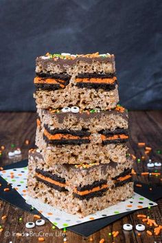 a stack of halloween rice krispy treats with sprinkles on the table