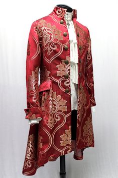 "A fantastic supernatural men's 17th century frock coat. The classic three quarter length coat is cut in rich blood red satin brocade with a woven gold motif. Twelve decorative vintage liberty coin buttons decorate the front, back and each cuff. The coat has a high classic mandarin collar. The back of the coat is very full and runs long in true frock coat style. Fully lined in black satin inside. Two roomy hip pockets on either side. We make it in sizes Small- 3X. This coat is AMAZING!! Size Mea Order Of The Dragon, Gold Motif, Mode Mantel, King Outfit, Hollywood Men, Frock Coat, Blood Red, Baroque Fashion, Red Satin