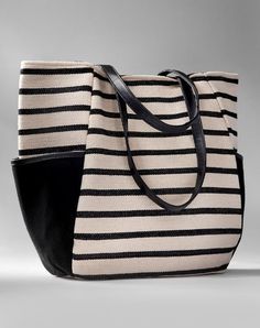 Casual and chic in a bold nautical stripe, this canvas herringbone carry all is strong and stylish. With side storage pockets, faux leather straps, full lining and pocketed interior. 100% Cotton. Everyday Striped Bags With Leather Handles, Black Travel Bag With Striped Lining, Striped Bag With Leather Handles For Everyday Use, Everyday Use Canvas Tote Bag With Striped Lining, Everyday Tote Canvas Bag With Striped Lining, Everyday Canvas Tote Bag With Striped Lining, Chic Travel Bag With Striped Lining, Striped Canvas Shopping Bag, Canvas Bags With Striped Lining For Everyday Use