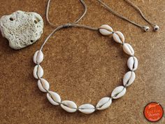 "This bohemian choker features thirteen natural cowrie sea shells adorned with wheat color waxed threads. Perfect for that casual boho style you can wear every day.  The necklace is adjustable in length with a sliding knot, so that you can wear it short or long and the cord ends in two delicate endings with two howlite beads. Each Cowrie sea shell is around 18 mm. About Cowrie shell, \"The Giver of Life\": The mystical cowrie shell found in the islands of the Indian Ocean, is small, white and gl Cheap Shell Necklace For Festival, Natural Cowrie Shell Jewelry For Festivals, Adjustable Natural Cowrie Shell Necklace, Bohemian Cowrie Shell Choker For Summer, Summer Bohemian Cowrie Shell Choker, Adjustable Natural Shell Necklace For Festivals, Bohemian Strand Choker For Festivals, Bohemian Cowrie Shell Choker, Bohemian White Cowrie Shell Choker