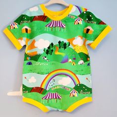 a green and yellow bodysuit with an image of a circus tent in the background